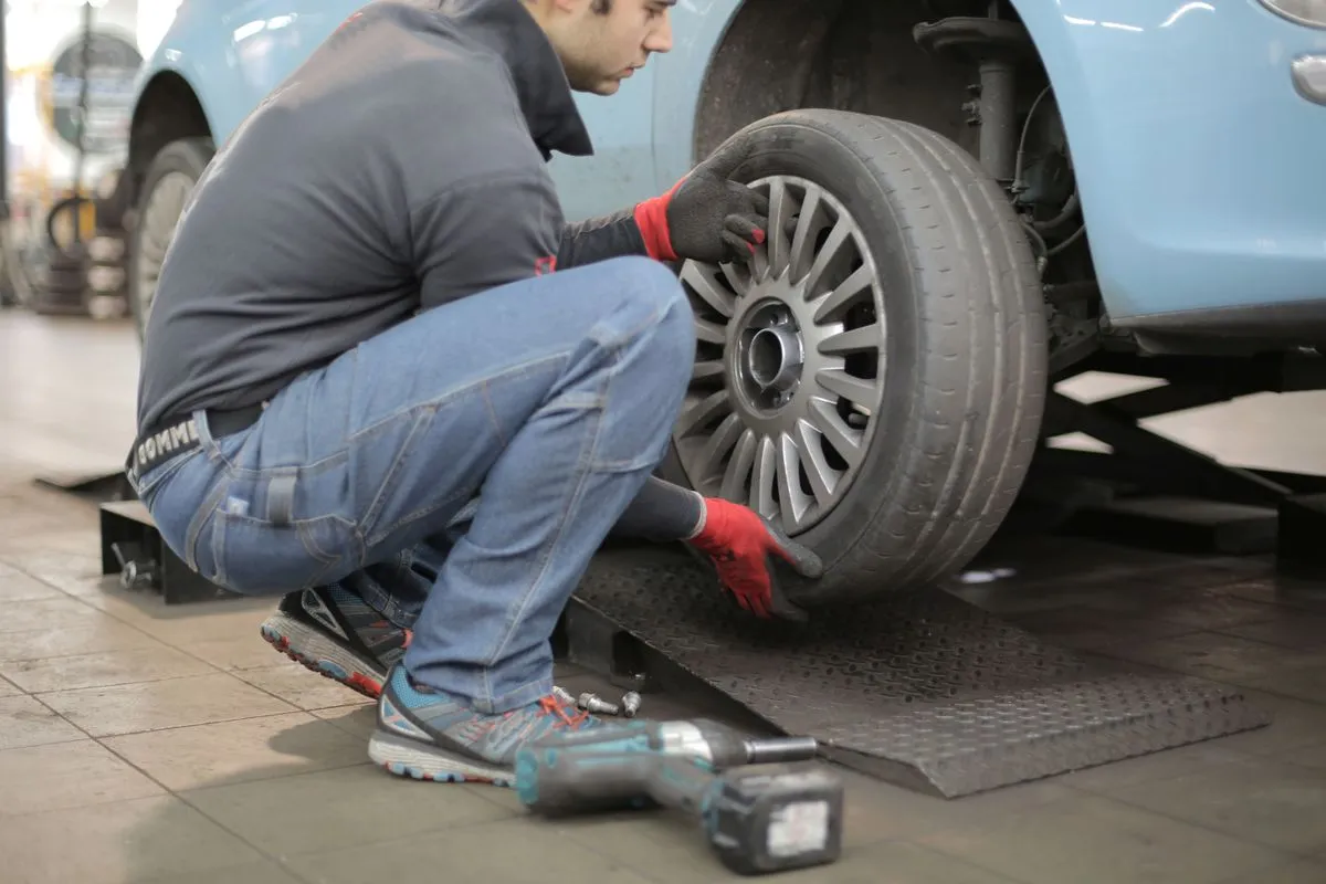 Mechanic inspecting brakes for a Hockley Heath customer