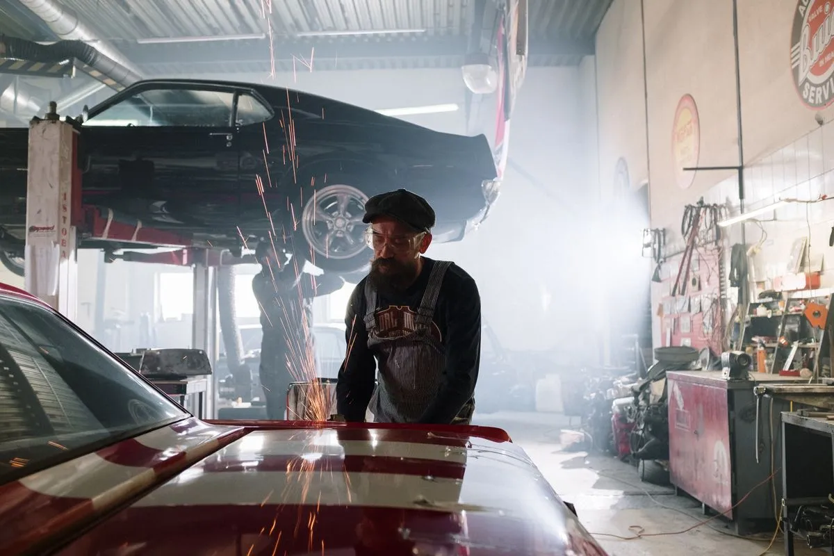 Car raised on a ramp with a mechanic working for a Kenilworth customer